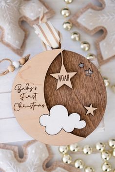 a wooden ornament with stars and clouds on it