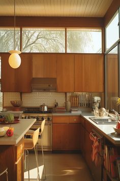 a kitchen filled with lots of wooden cabinets and counter top space next to a window