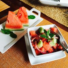 watermelon and onion salad with mint garnish in small white dishes on a place mat