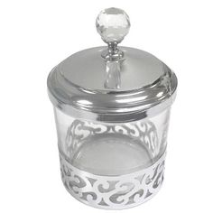 an ornate glass jar with a metal lid