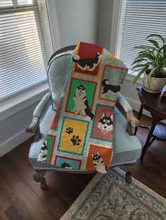 a chair with a cat quilt on it