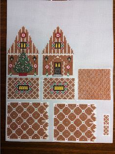 a cross - stitch pattern with houses and trees on the front, along with other patterns