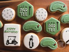 decorated cookies with golf related items on a wooden tray for a birthday or baby shower