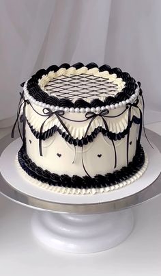 a white and black cake sitting on top of a table