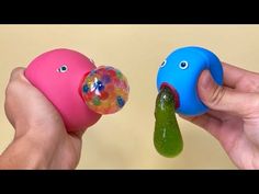 two handmade toys are being held up to show the same thing in each other's hands