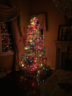 a brightly lit christmas tree in a living room