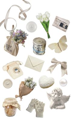 many different items are arranged in the shape of a heart and an envelope with flowers on it