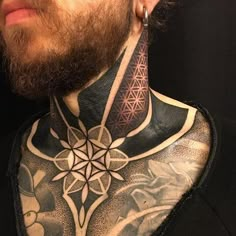 a man with tattoos on his neck and chest