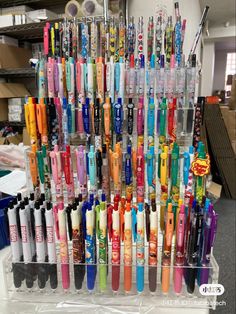 there are many different colored toothbrushes in this display case on the counter top