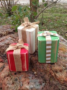 three wrapped presents sitting on top of a rock