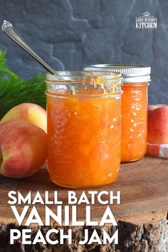 small batch vanilla peach jam in two jars on a wooden table with apples and leaves