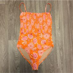 This Orange And Pink Floral One-Piece Swimsuit Is So Gorgeous! It Has A Smocked Bandeau Design In The Top Half, Removable/Adjustable Shoulder Straps, Removable Pads With A Built In Bra, And A Straight Neckline. It Has Good Coverage And Feels Secure. I Have Another Color In This Swimsuit That I Really Love Wearing, But I Have Never Worn This One - It Is Brand New And Unused. Non-Smoker Fast-Shipper Stretch One-piece For Spring Beach Party, Stretch One-pieces For Spring Beach Party, Stretch One Pieces For Spring Beach Party, Spring Pink Printed One-pieces, Stretch Pink One Piece For Spring, Pink Stretch One-piece For Spring, Casual Pink One-piece Swimsuit For Pool, Spring One-piece For Beach Party, Spring Pink Stretch One Piece