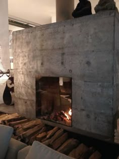 a living room filled with furniture and a fire place next to a wall mounted fireplace