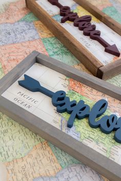 two wooden signs that say explore and the word explore is on top of a map