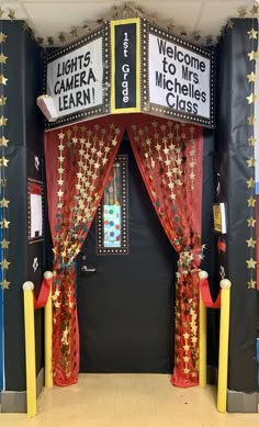 a door decorated with red curtains and yellow poles for an entrance to a movie theater