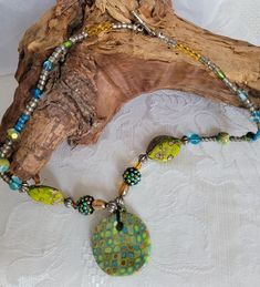 I make all of my polymer clay focal beads right here in my studio. Chartreuse, robins egg blue, gold and brown are the perfect color combo for this mod cane pendant.  Paired with unique and one of a kind beads to highlight these great colors, this necklace can be your all seasons accessory.  Just large enough to grab your attention, but not large enough to overwhelm, this piece will be the focus of any great outfit.  About 20 inches in length with a sterling silver toggle clasp.  This necklace i Bohemian Polymer Clay Round Beads Jewelry, Green Bohemian Polymer Clay Jewelry, Polymer Clay Round Beads For Jewelry Making, Handmade Green Polymer Clay Necklace, Cane Polymer Clay, Serpentine Necklace, Puzzle Piece Necklace, Dichroic Glass Jewelry, Jewellery Shop Design