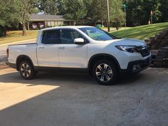 a white truck parked in front of a house