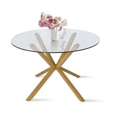 a glass table with wooden legs and flowers