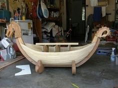 a wooden boat being built in a shop