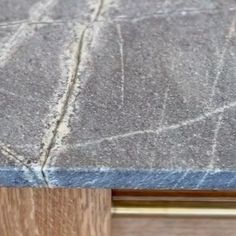 a close up view of the top of a table with wood and cement on it