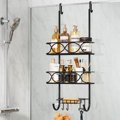 a bathroom shelf filled with lots of bottles and soaps next to a shower head