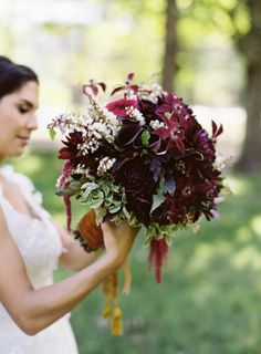 a woman holding a bouquet in her hand