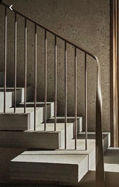 the stairs are made of concrete and have metal handrails