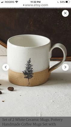 a coffee mug sitting on top of a table next to some coffee beans and other items