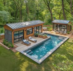 a small pool house in the middle of a wooded area