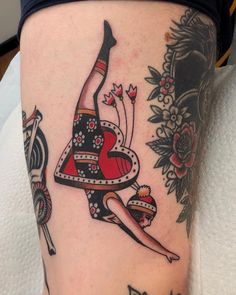 a woman's leg with a tattoo on it and a heart in the middle