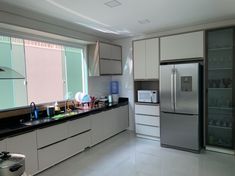 a kitchen with stainless steel appliances and white cabinets