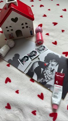 the contents of a personal care product are laid out on a bed with red hearts