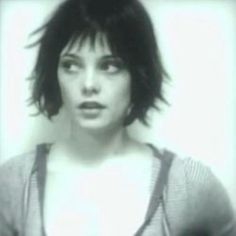 a black and white photo of a woman with short hair