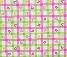 a pink and green checkered fabric with flowers on it