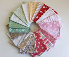 a bunch of different colored fabrics arranged in a circle