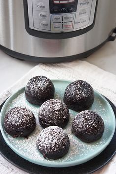 chocolate donuts on a plate in front of an instant pot