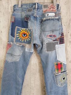 an old pair of jeans with patches on them