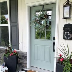 the front door is decorated with flowers and plants