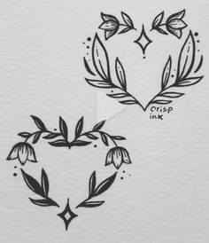 two heart shaped tattoos with leaves on them