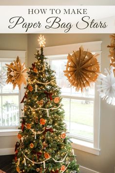 a decorated christmas tree in front of a window with the words how to make paper bag stars