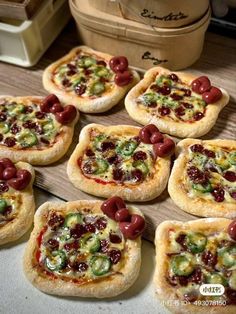 small pizzas with olives and peppers on them