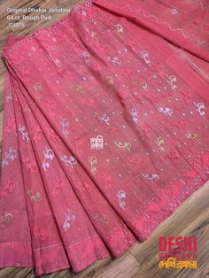 Take Your Sartorial Game To A New Level With Elegant Jamdani Sarees This is a Dhakai Jamdani Saree, Original Bangaladeshi, Rough Pink color with Floral theme, Machine thread and Zari work, Handwoven Halfsilk, 64 count, Traditional Elegant Saree **Halfsilk Jamdani ** Fall, Piku, Tussle Done.  **64 count, ** Unstitched Blouse pc  Whether you are meeting your friends for a fun brunch or attending a corporate event, Jamdani Sarees will make you stand apart in the crowd. Explore Jamdani sarees in a wide variety of patterns like Zari, Resham and Abstract Prints available in a wide spectrum of colors. Designer Jamdani silk sarees are also popular as Wedding Wear Sarees Traditional Pink Lehenga With Motifs, Pink Semi-stitched Lehenga With Motifs, Traditional Drape Pink Lehenga With Motifs, Transitional Pink Salwar Kameez With Pallu, Traditional Pink Blouse Piece With Zari Work, Silk Thread Traditional Wear With Motifs For Puja, Pink Silk Thread Sets For Festivals, Festive Pink Silk Thread Traditional Wear, Festive Pink Traditional Wear In Silk Thread