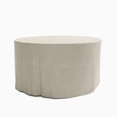 a round table with a white cover on it's top and the bottom half covered in fabric