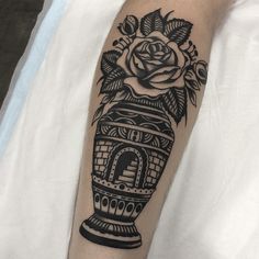 a black and white photo of a vase with flowers on it's side arm