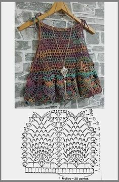 a crocheted dress hanging on a brick wall next to a pattern for the skirt