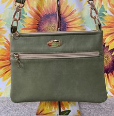 "Soft luxurious feel faux leather in olive green paired with light gold quality hardware gives this crossbody a classy and stylish look. Med-size slim profile bag.  Perfect as your everyday bag.  Features: *Exterior front zipper pocket  *Interior zipper pocket  Measurements: 11\" W x 8\" H x 1⁄2\"D Strap length: 55\" max Please visit my shop to see more handmade bags, wallets, wristlets, totes and more... https://www.etsy.com/shop/Thefancybaglady" Medium Crossbody Bag, Handmade Handbag, Handmade Purse, Green Handbag, Handmade Purses, Handmade Handbags, Womens Purses, Everyday Bag, Medium Bags