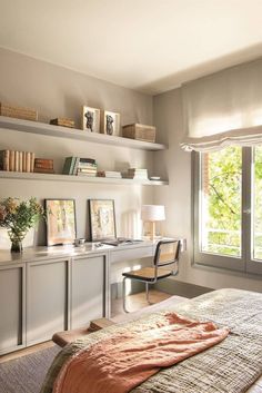 a bedroom with a bed, desk and shelves on the wall