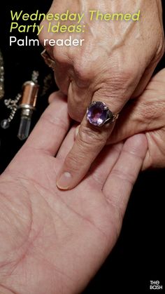 a person's hand holding an amethyst ring with the words wednesday themed party ideas palm reader