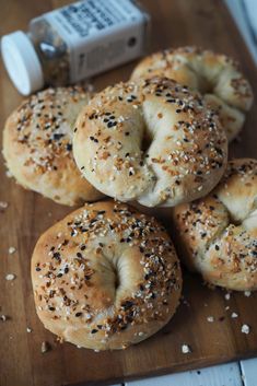 sesame seed bagels on a wooden cutting board