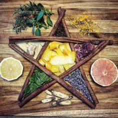 an arrangement of herbs and spices arranged in the shape of a star on a wooden table